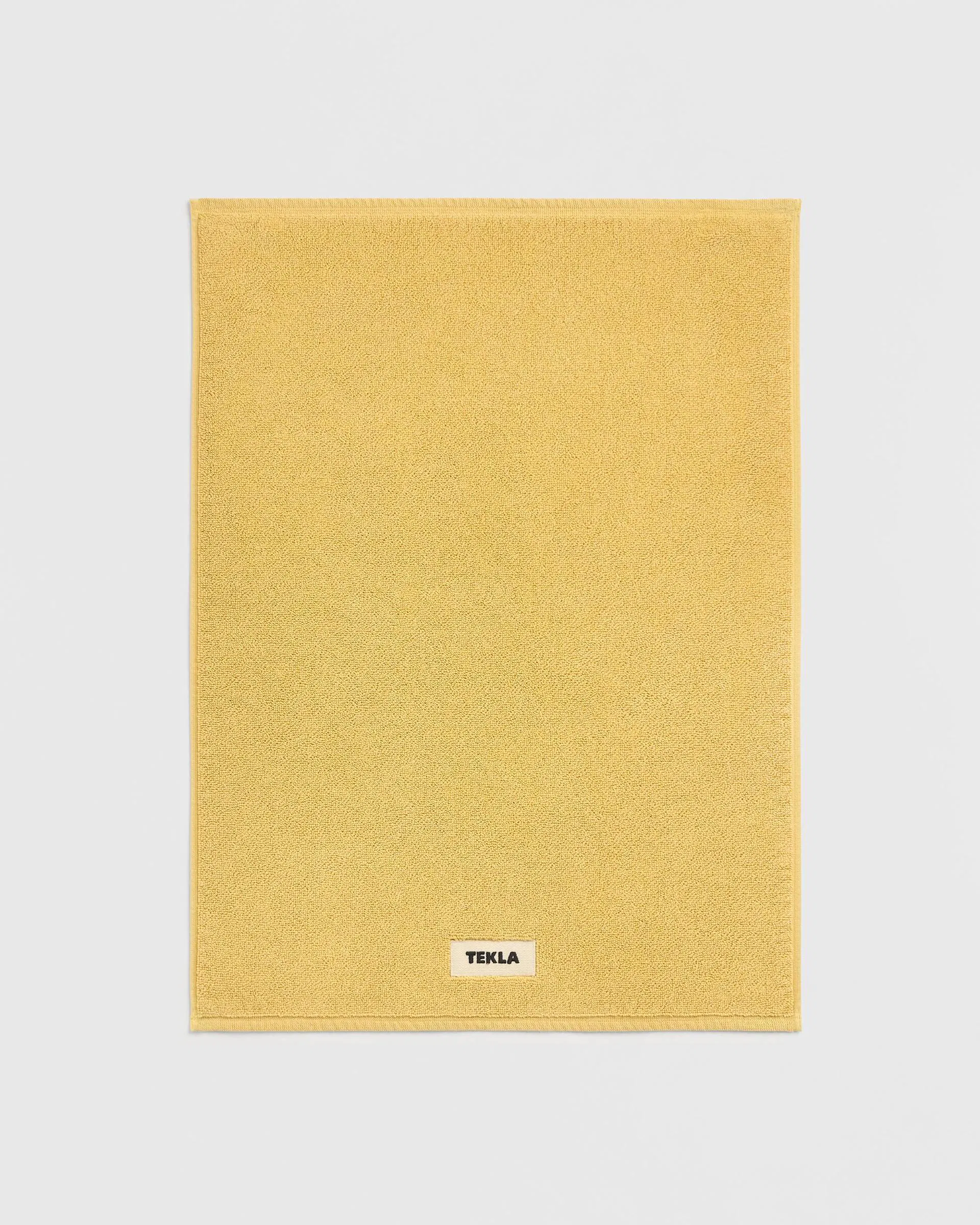 Tekla Fabrics Bath mat – solid – Yellow Ochre